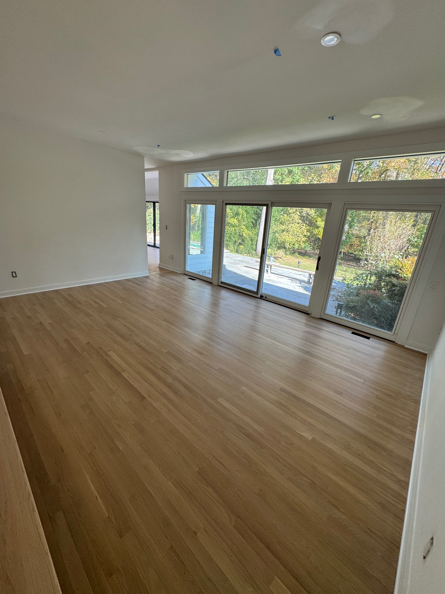 Sunlit great room with newly installed hardwood floors