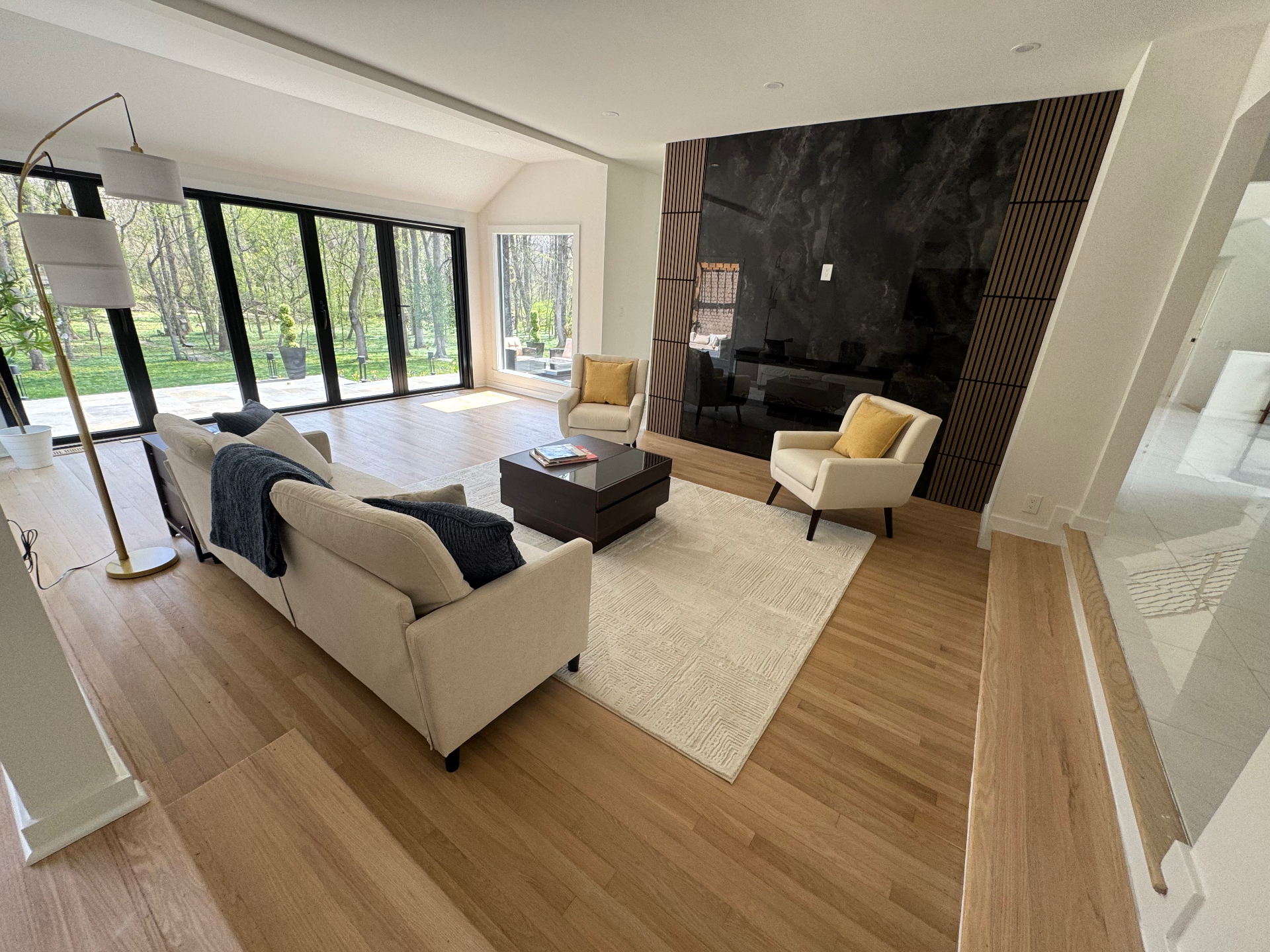 Living room flooring near fireplace with fresh hardwood finish