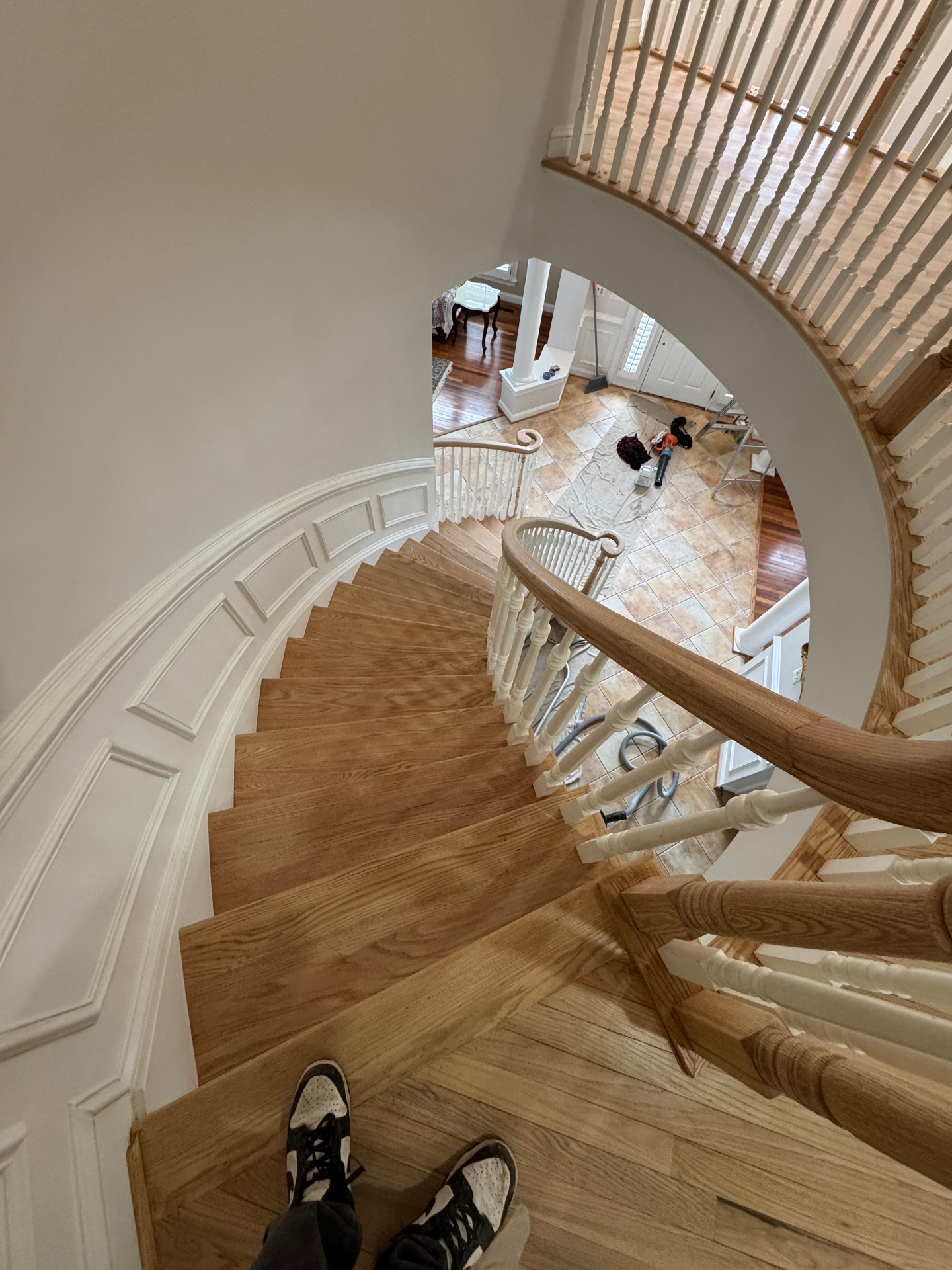 Modern hardwood staircase with warm gold lighting
